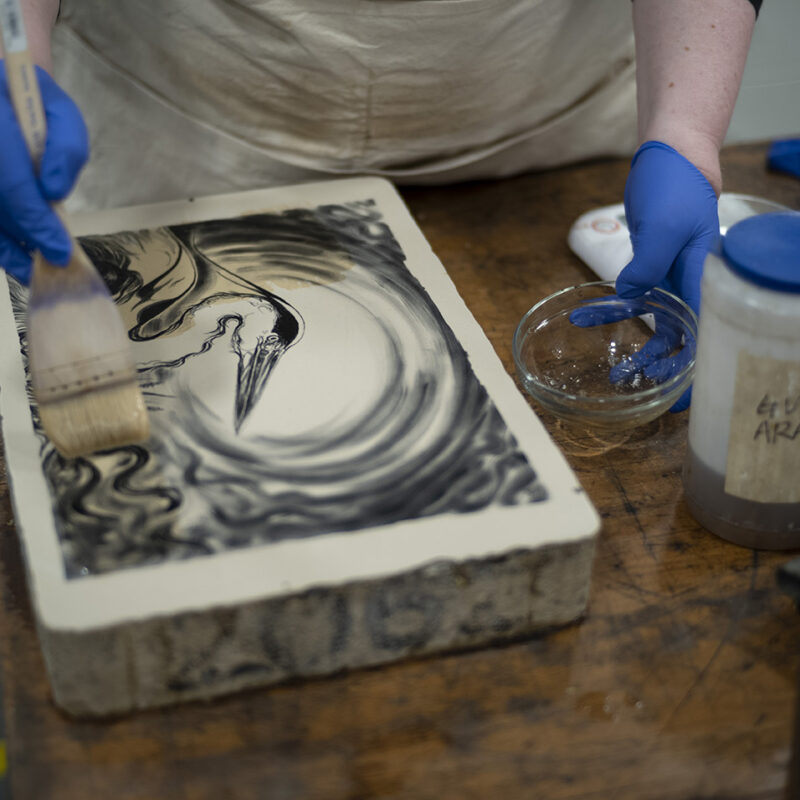   Georgina Coburn applying the first etch to lithographic stone  © Photo John Mc Naught Highland Print Studio